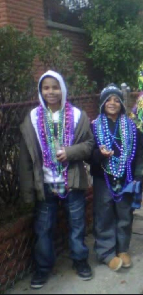Austin and Barake celebrating with Mardi Gras beads