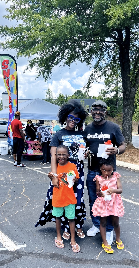 Team Supreme family enjoying snoballs at event