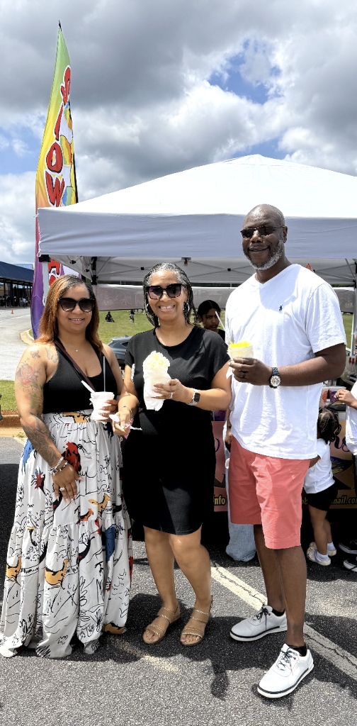 Three happy guests posing with snoballs