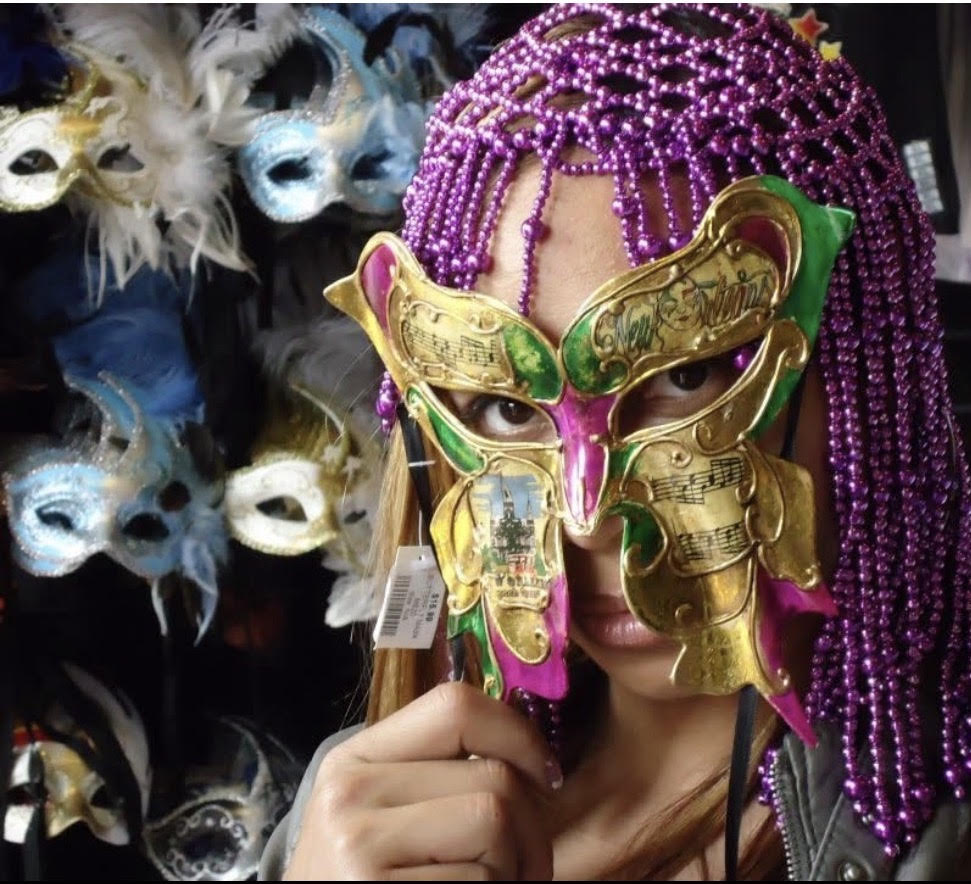 Owner Bianca Sexton wearing a beautiful New Orleans Mardi Gras mask